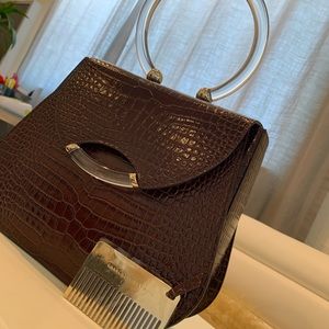 Charlotte Olympia croc- embossed leather handbag.